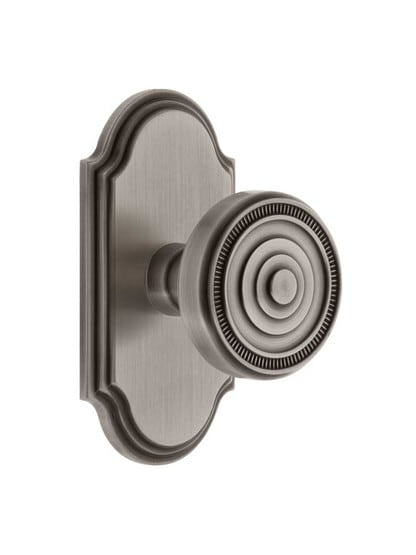 Grandeur Arc Rosette Door Set with Soleil Knobs in Antique Pewter.
